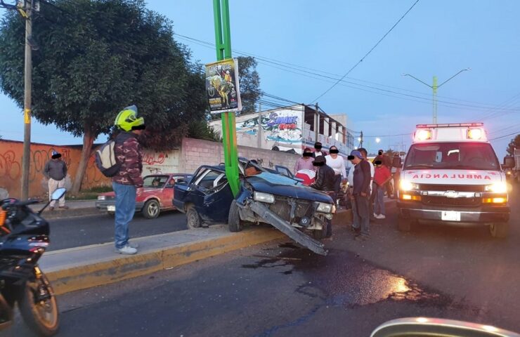 Un auto accidentado en el Boulevard Quetzalcóatl, una ambulancia y varias personas en la ciudad de Tulancingo